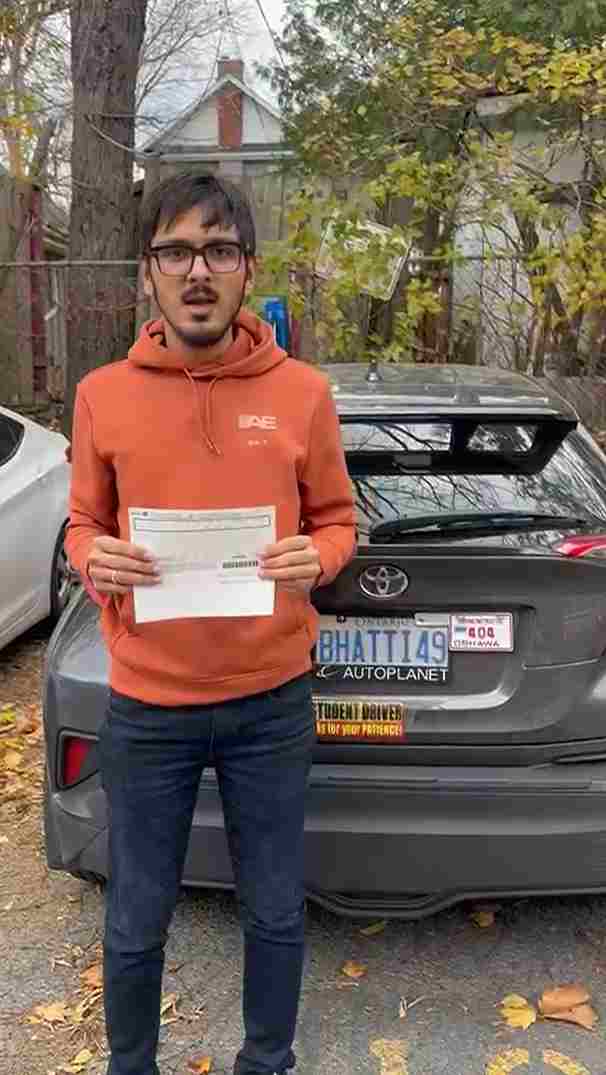 boy holding a driving licence certificate after completion of traing by drive vision school